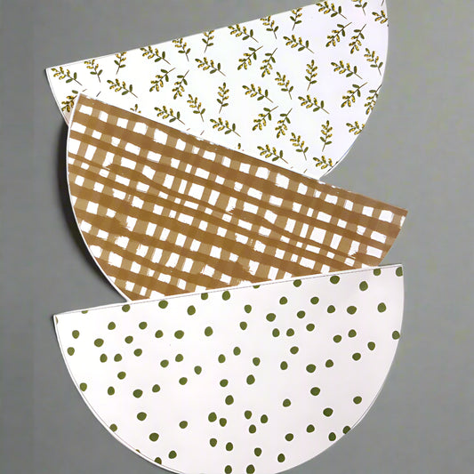 Three bunting flags in scalloped shape with different patterns on a grey background