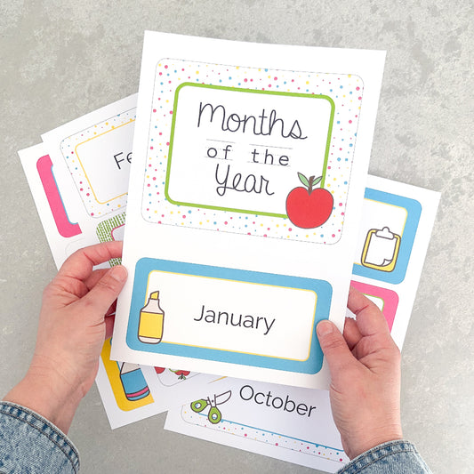 Colourful educational cards with months of the year on a grey surface