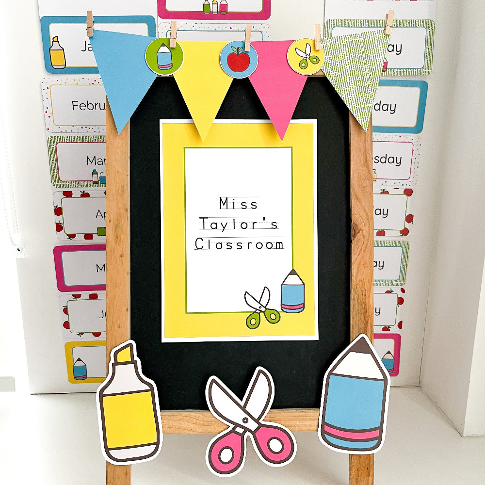 Decorative classroom sign with 'Miss Taylor's Classroom' text, surrounded by colorful paper cutouts of school supplies.