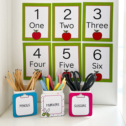 Children's school supplies with educational number cards and stationery containers on a white background