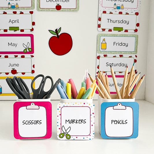Colourful school supply caddies with labeled items on a white background