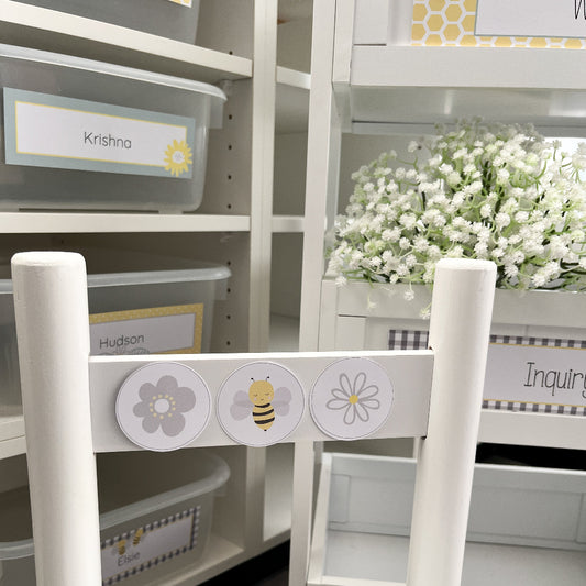 White storage unit with labeled bins and decorative elements