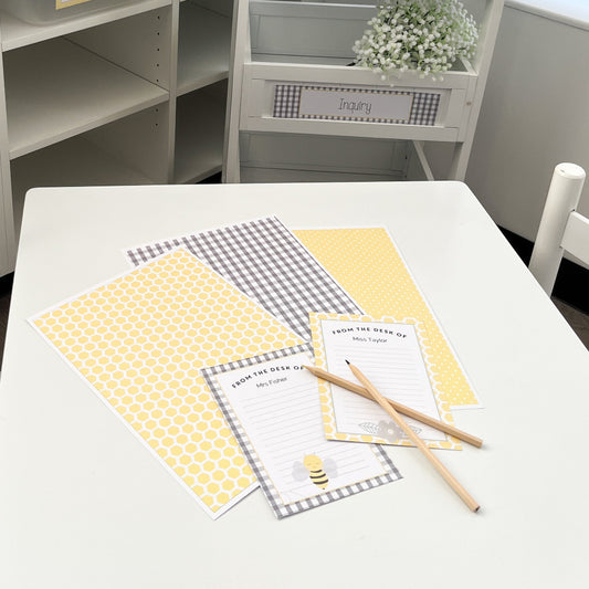Children's classroom setup with white furniture, yellow accents, and educational materials.