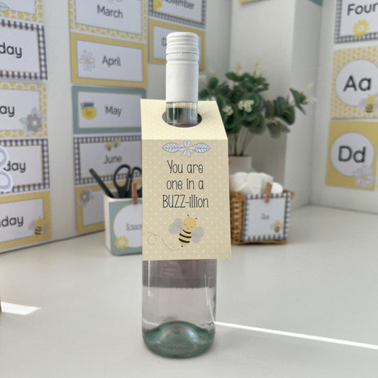 Bottle with a decorative tag in front of educational posters