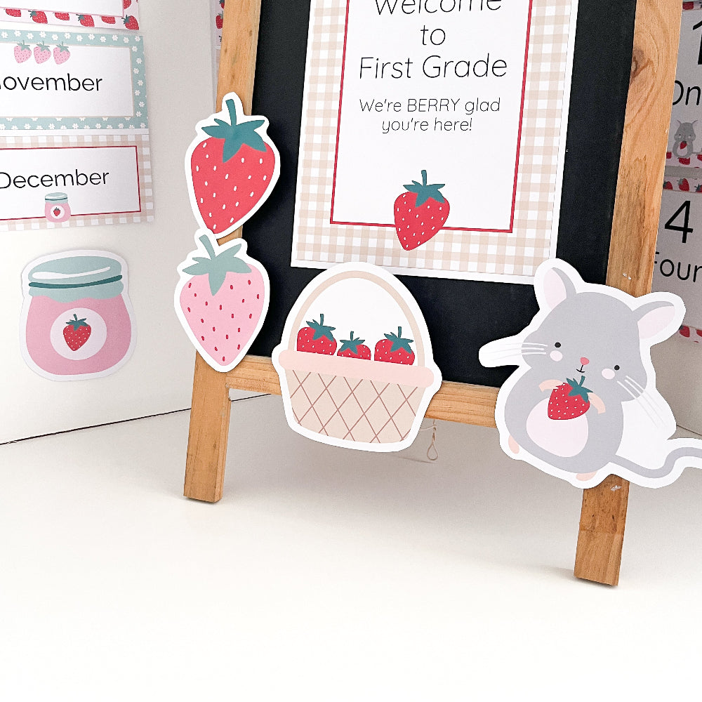 Educational posters and decorative items with strawberry theme on a wooden stand.