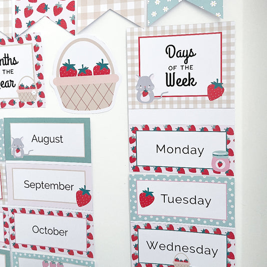 Educational children's calendar with days of the week and strawberry-themed design.