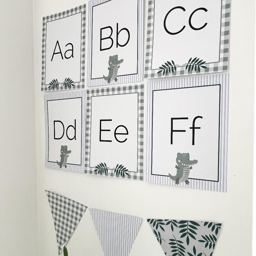 Printable Alphabet Cards in a Crocodile classroom theme on a white wall.