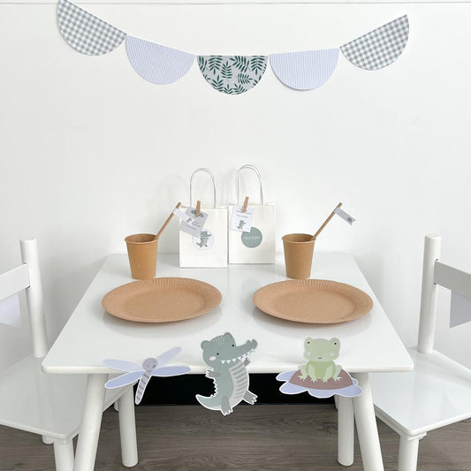 Crocodile Themed Party Set up with scalloped bunting flags on white table and chairs