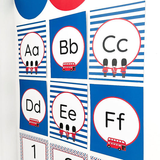 Educational alphabet cards with British-themed illustrations on a blue and white striped background.
