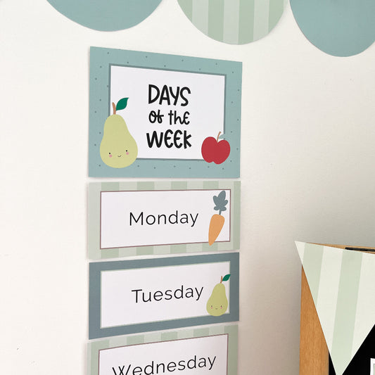 Children's educational chart with days of the week labels on a whiteboard.