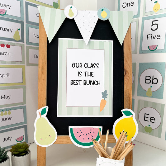 Decorative classroom setup with a blackboard, colorful cutouts, and educational posters.