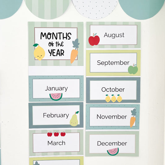 Educational posters for months of the year with colourful fruit illustrations on a light background.