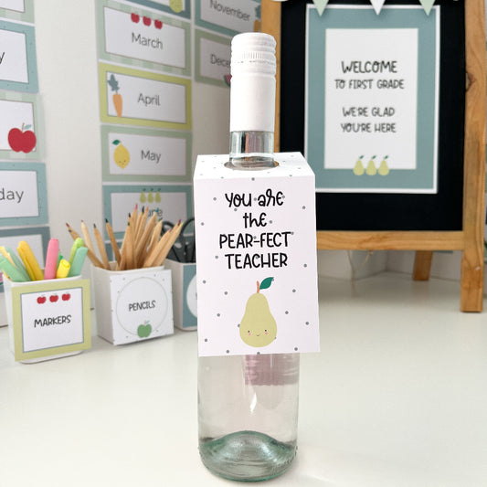 Decorative bottle with a label reading 'You are the pear-fect teacher' in a classroom setting.
