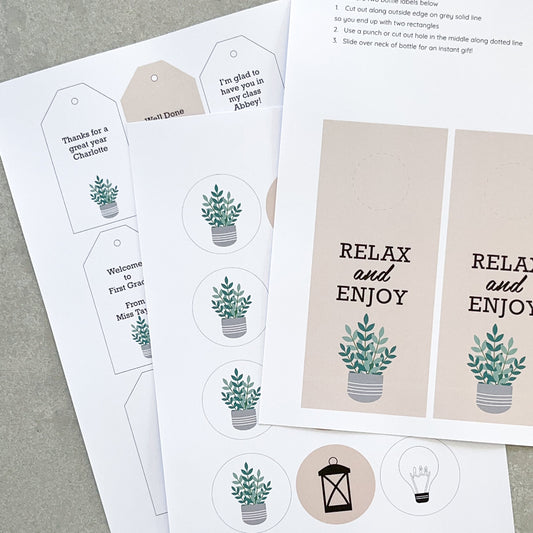 Various labels to help wrap gifts are displayed on a grey bench.