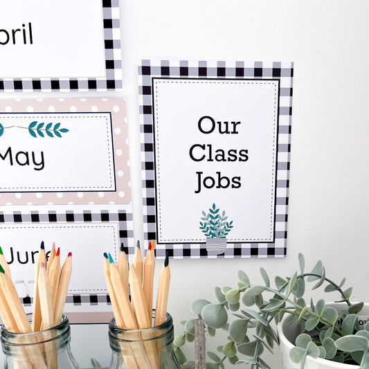 Small printable sign on white wall that says 'class jobs'. There is black gingham squares on the border and pencils in the foreground.