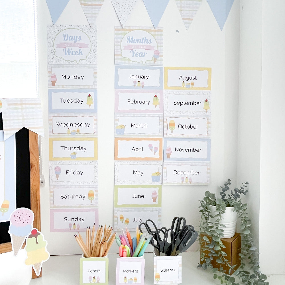 Educational wall charts for days of the week and months of the year in pastel colours on a white wall in a classroom setting.