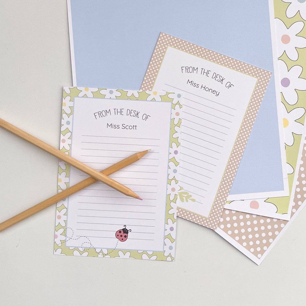 Coloured paper with personalised stationery designs on a light surface