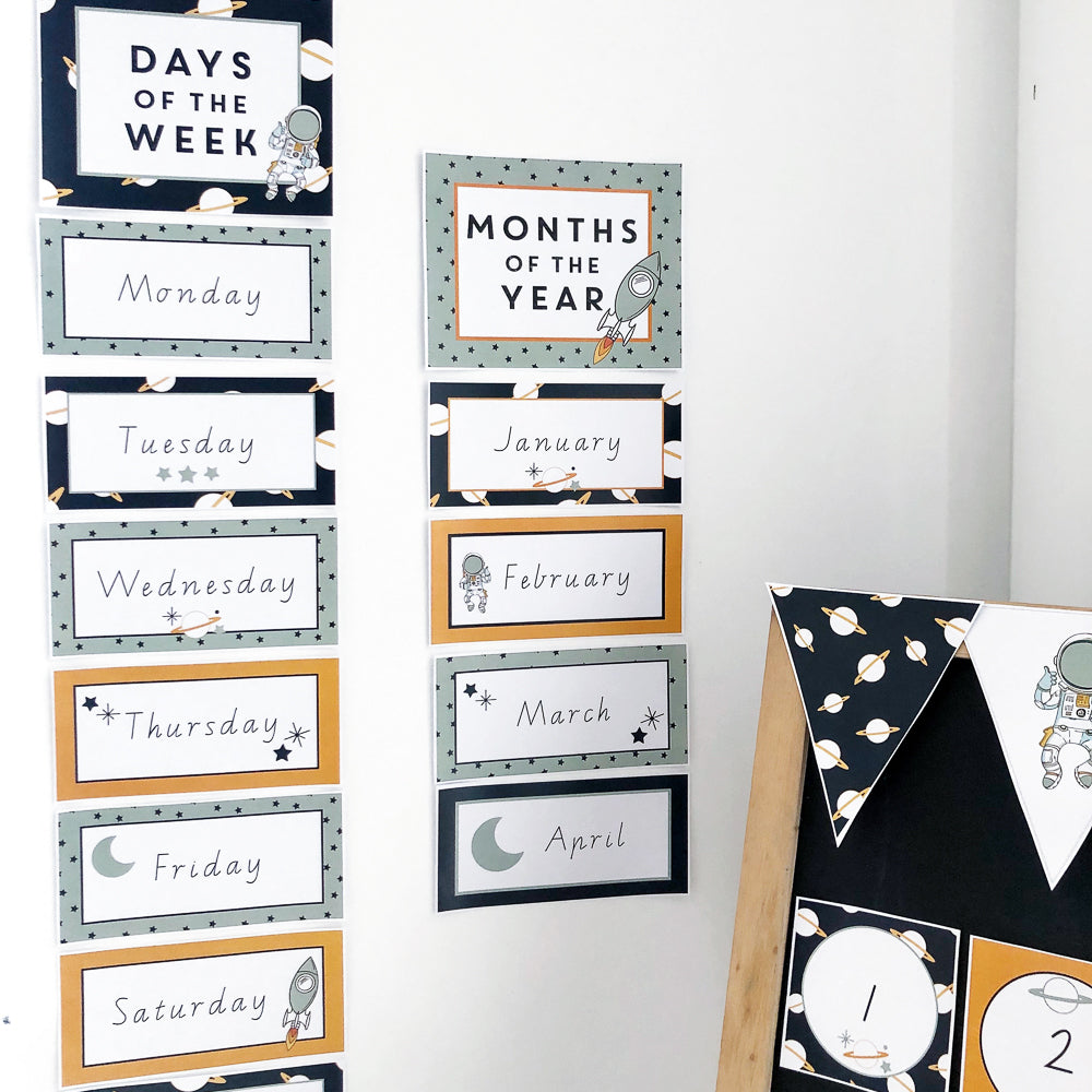 Space theme Classroom days and months charts on a white wall.