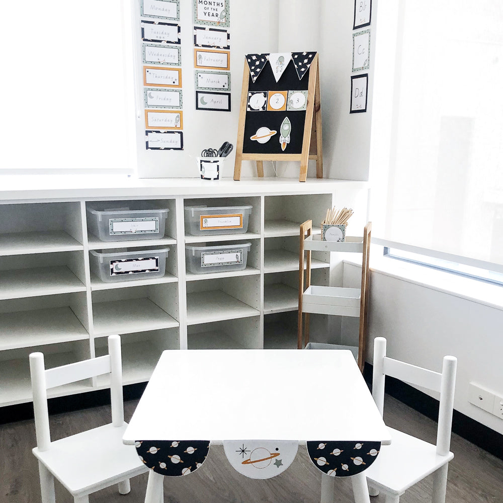 Space themed Classroom Set up with white table and chairs.