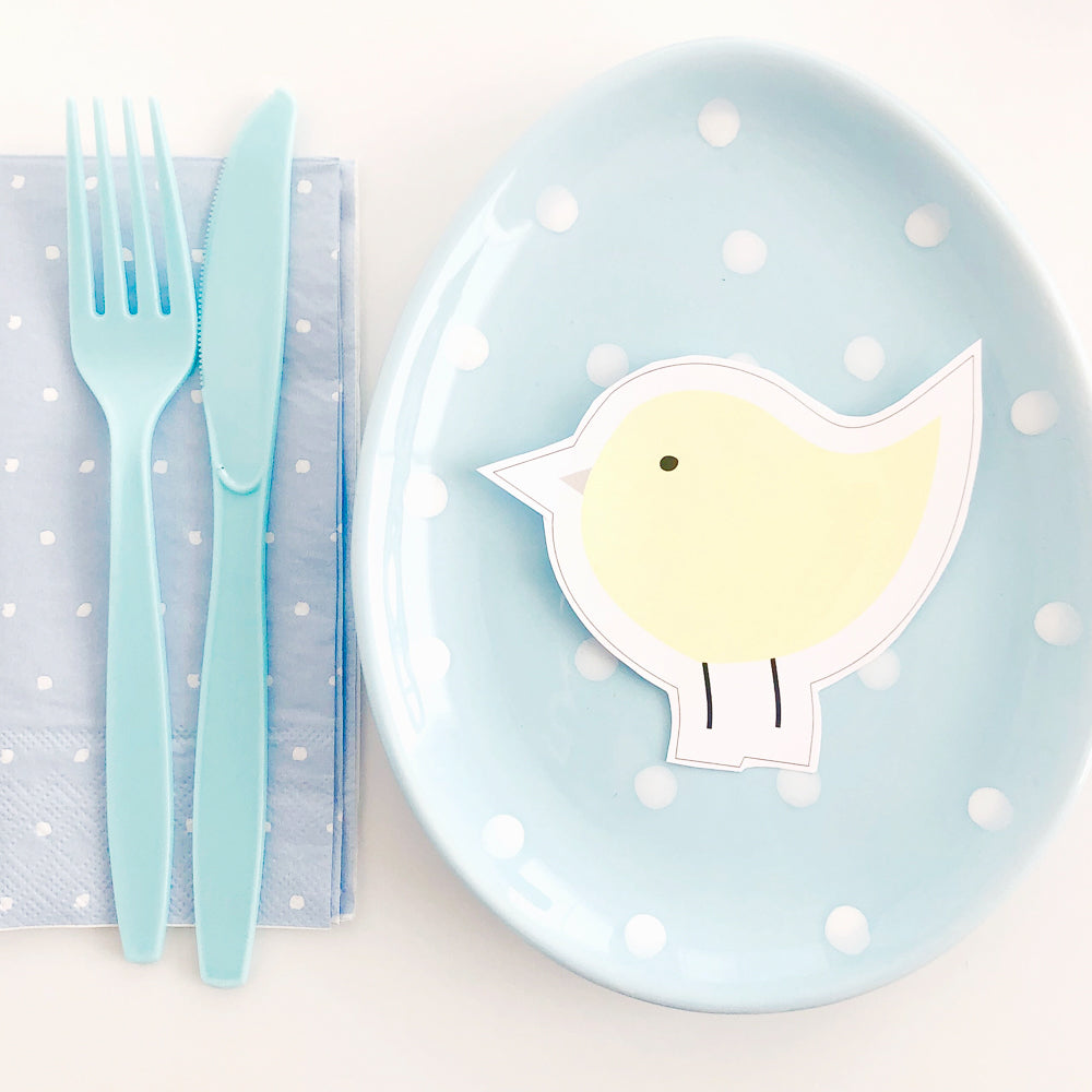 Easter Chick download for diy craft and party displayed on pastel blue plate with polka dots.