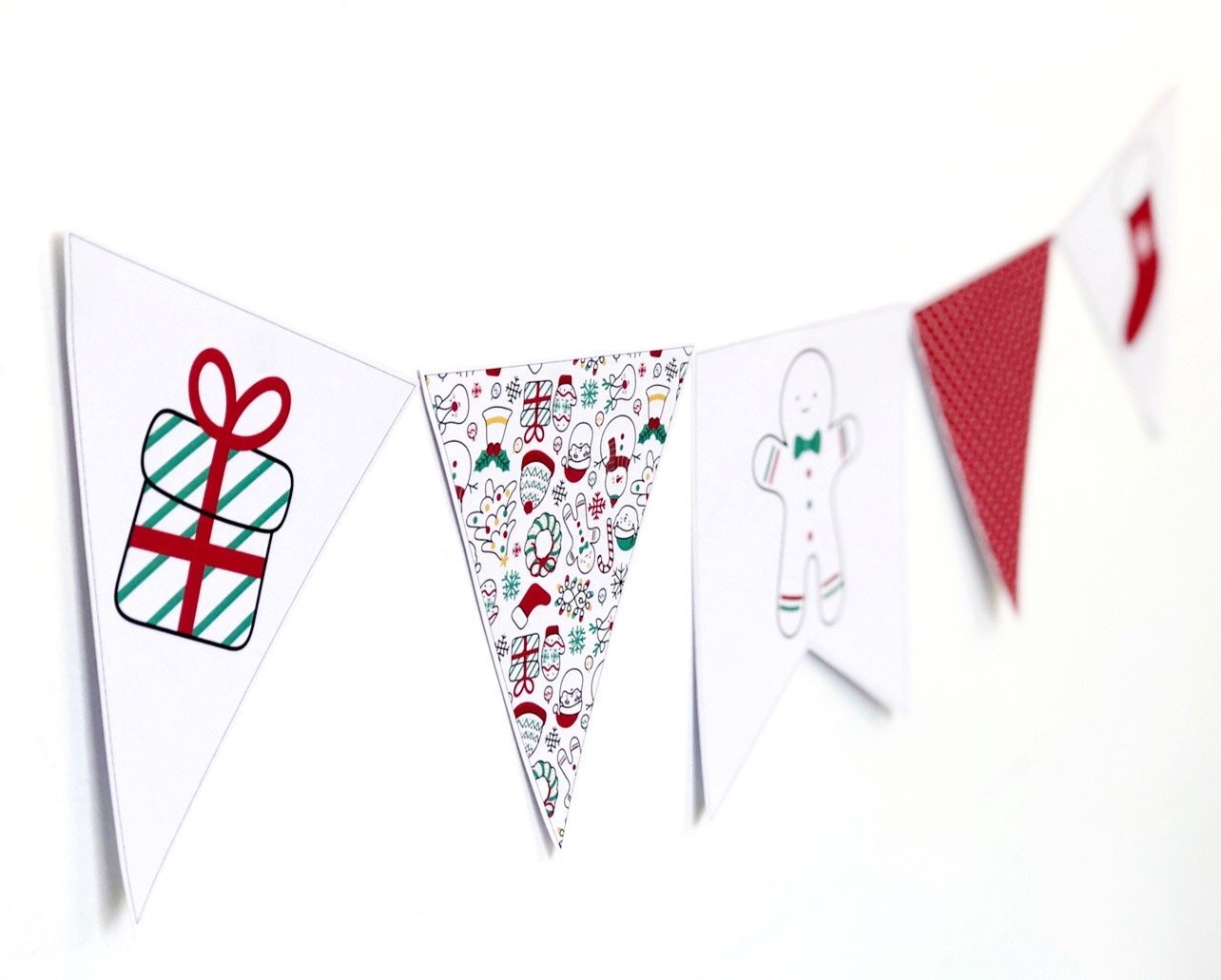 Bright Red and Green Christmas themed bunting flag on white wall.