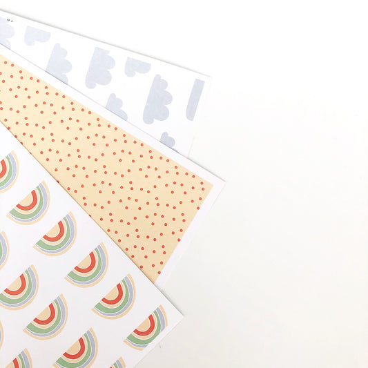 Rainbow themed patterned papers displayed on a white background.