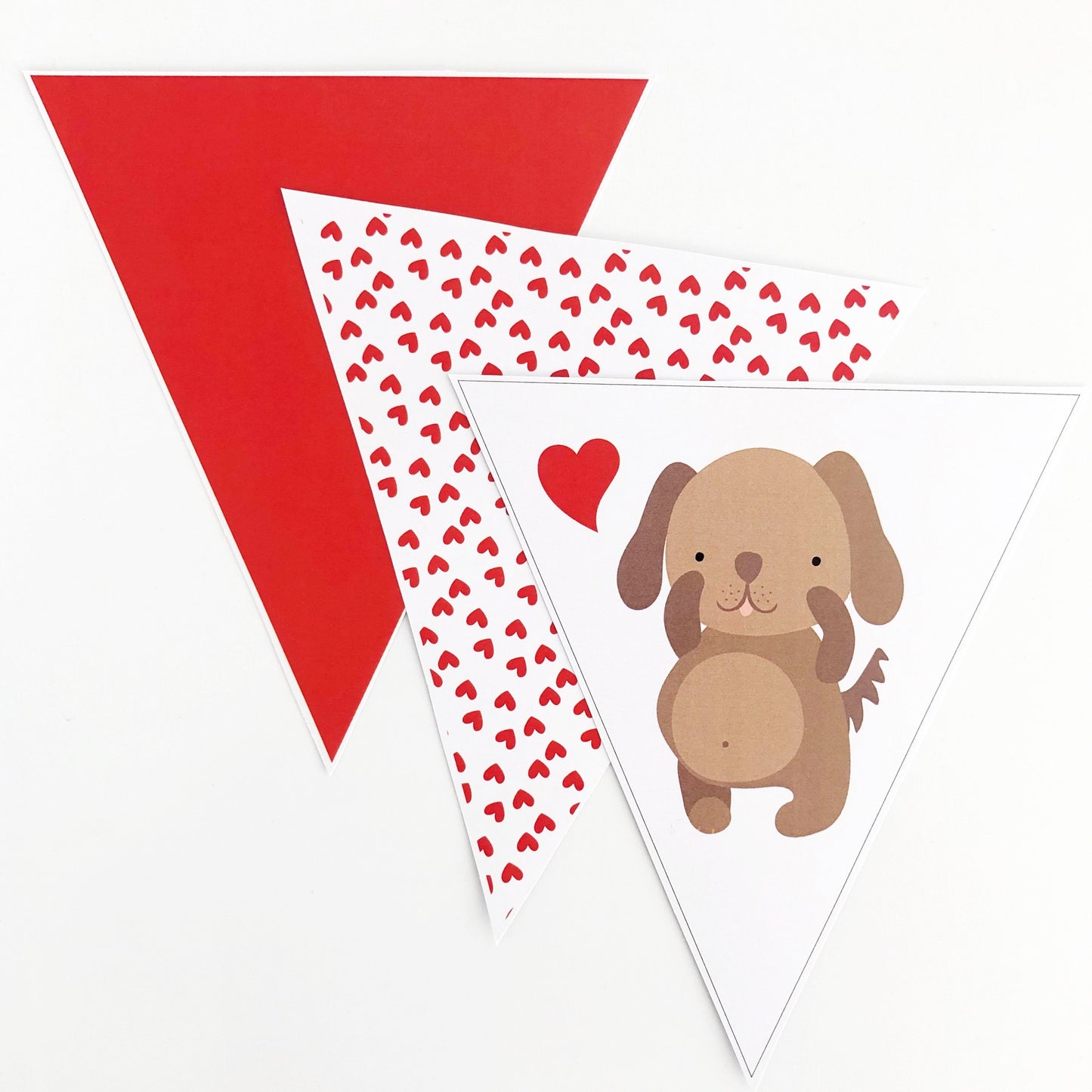 Cute valentines bunting flag with puppy and red love hearts on white background