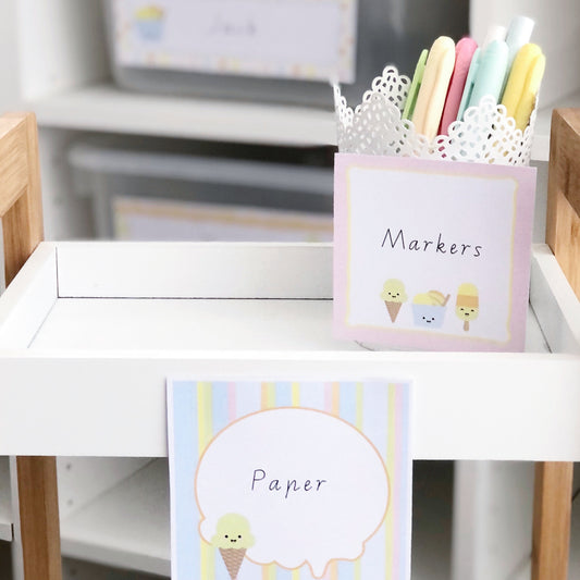 Ice cream and sorbet theme classroom labels are placed on a teacher trolley and caddy with markers.