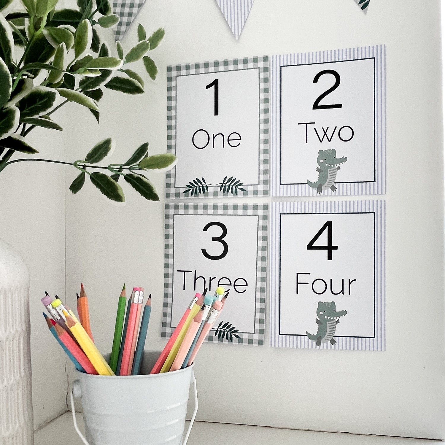 Classroom numbers on wall. The numbers are in frames with Crocodile theme.