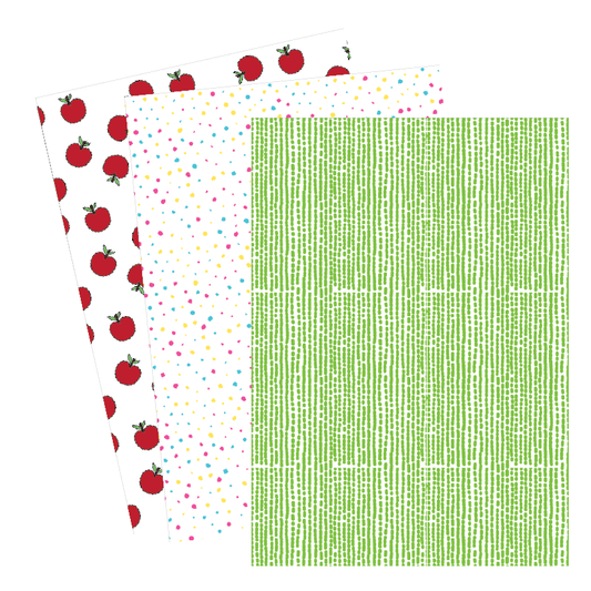 Three sheets of paper with different patterns: red apples on white, colorful confetti, and green grid.