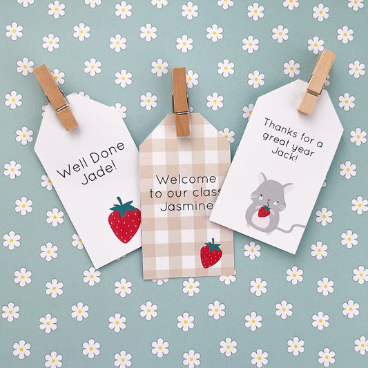 Three personalised tags with messages and graphics on a floral background
