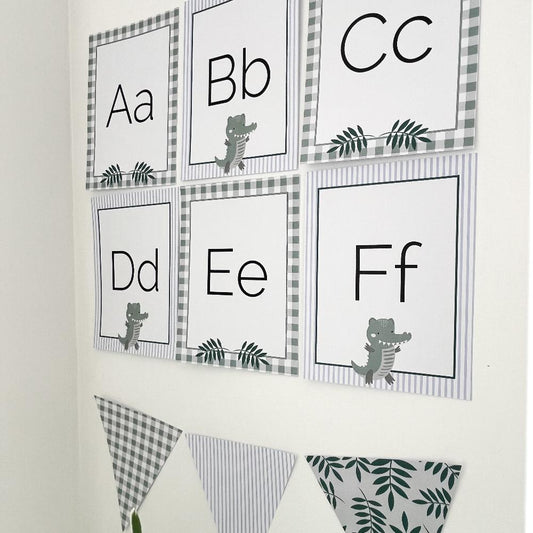 Printable Alphabet Cards in a Crocodile classroom theme on a white wall.