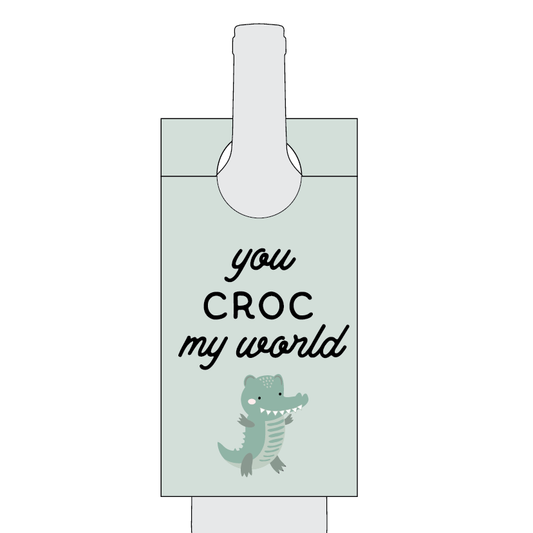 Cartoon alligator with text 'you CROC my world' on a light green background