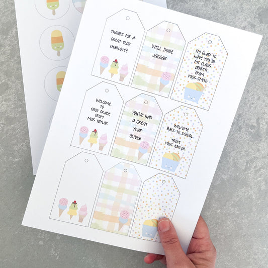 Sheet of printed gift tags with ice cream cone designs on a grey surface.