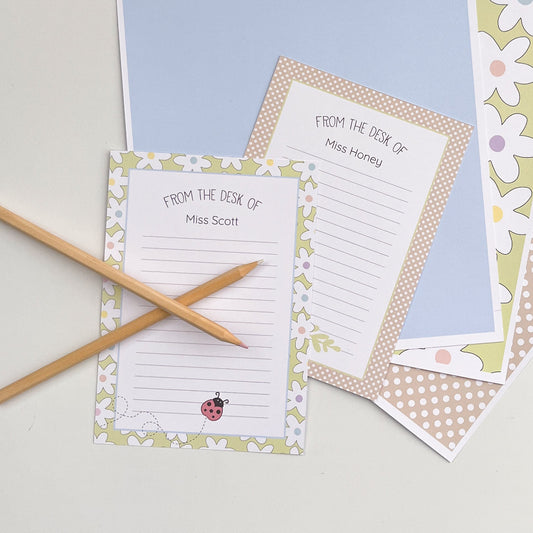 Coloured paper with personalised stationery designs on a light surface
