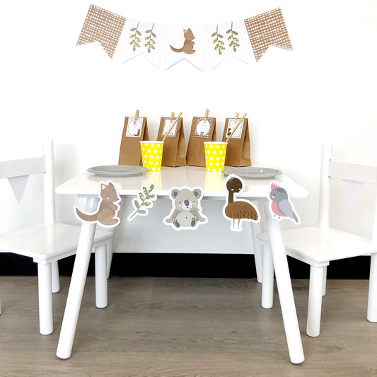 Party set in in an Australian Theme with a white table and chairs. There are cute Australian Animals Stuck on the table. 