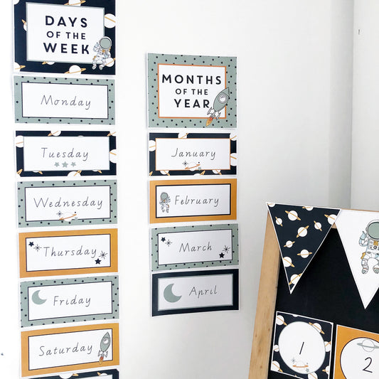 Space theme Classroom days and months charts on a white wall. 