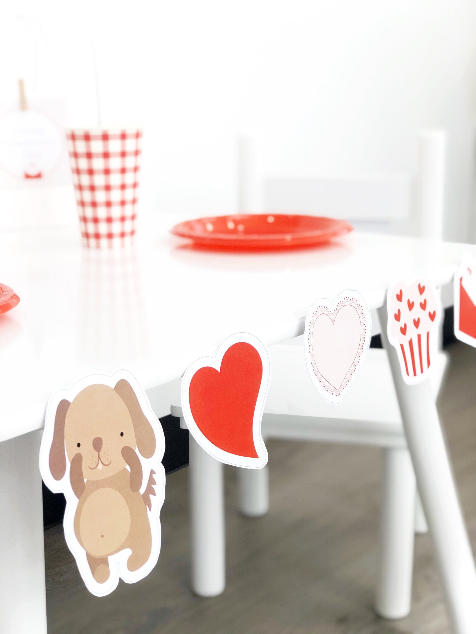 Cute valentines day cut outs with puppy and love hearts on white table