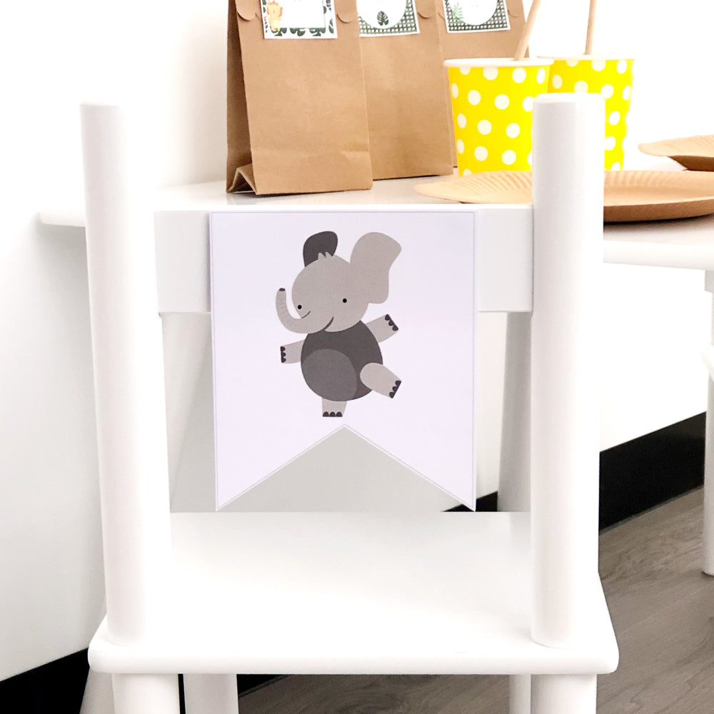 Cute elephant bunting flag on a white chair with party items in the background